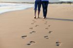 couple walking on the beach concept