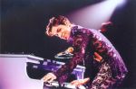 Prince playing piano in concert concept