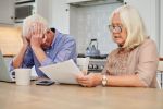 Shot of a senior couple looking unhappy while going through paperwork at home. Disinheritance clause concept.